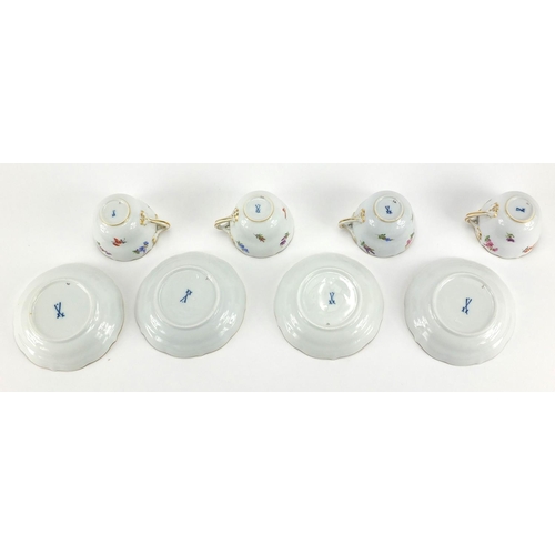 583 - Four Meissen tea cups and saucers, each hand painted with flowers and with crossword marks to the ba... 