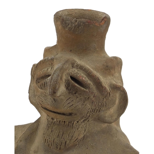 563 - Columbian pottery figure of a man, 25.5cm high