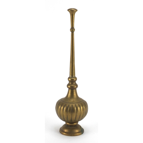 559 - Persian brass water dropper, engraved with flowers, signed around the foot rim, 35cm high