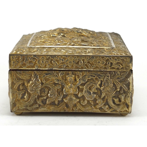 555 - Burmese/Thai silver box, profusely embossed with figures amongst foliage, character marks to the bas... 