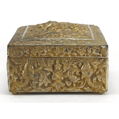 555 - Burmese/Thai silver box, profusely embossed with figures amongst foliage, character marks to the bas... 