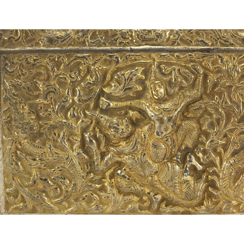 555 - Burmese/Thai silver box, profusely embossed with figures amongst foliage, character marks to the bas... 