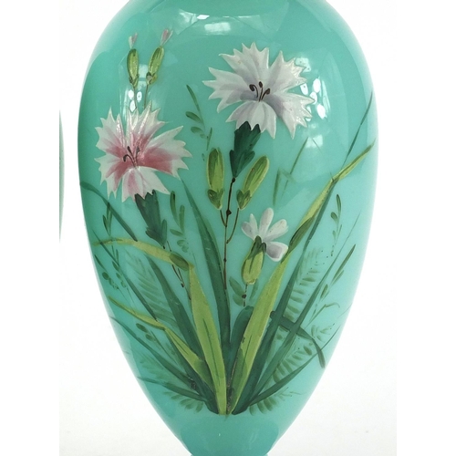 620 - Pair of Victorian turquoise opaline glass vases both hand painted with flowers, each 26cm high