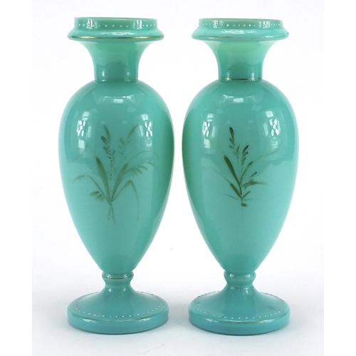 620 - Pair of Victorian turquoise opaline glass vases both hand painted with flowers, each 26cm high