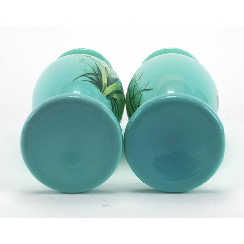 620 - Pair of Victorian turquoise opaline glass vases both hand painted with flowers, each 26cm high