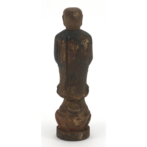 466 - Chinese carved wooden figure of Buddha with remnants of paint, 31cm high