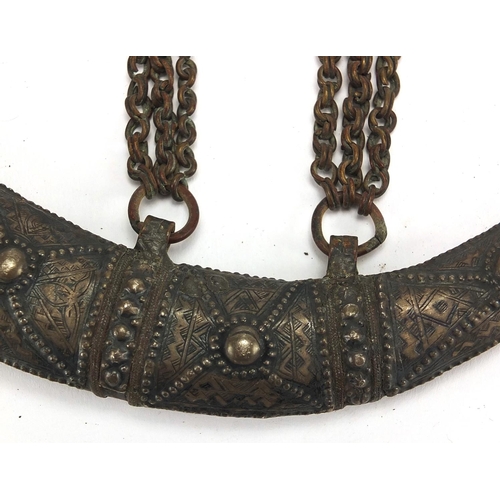 560 - Middle Eastern silver coloured metal sheath, engraved with stylised motifs, 19cm in length