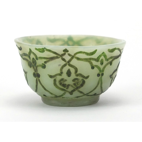 545 - Islamic green jade cup incised with stylised floral motifs, 6cm in diameter