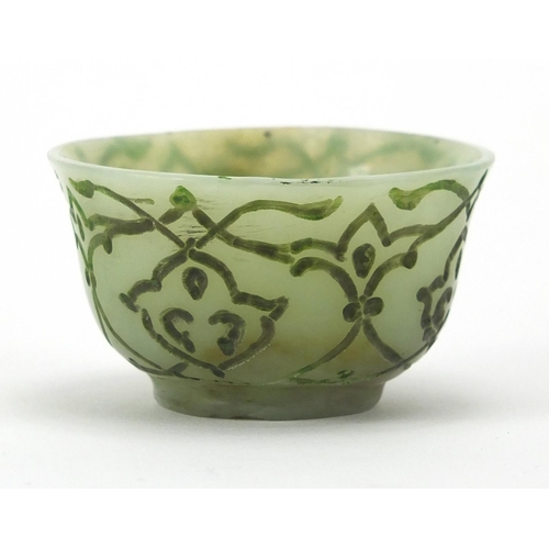 545 - Islamic green jade cup incised with stylised floral motifs, 6cm in diameter