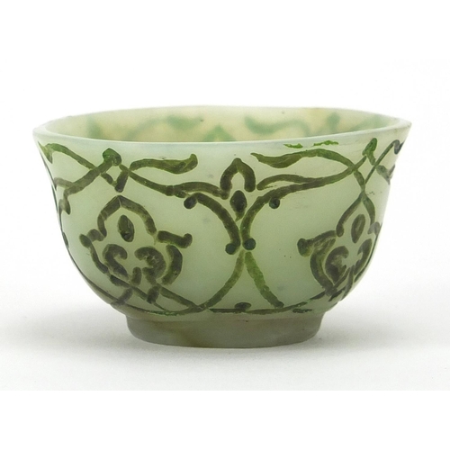 545 - Islamic green jade cup incised with stylised floral motifs, 6cm in diameter