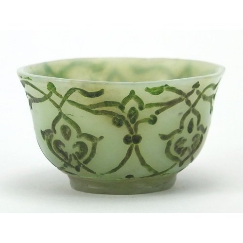 545 - Islamic green jade cup incised with stylised floral motifs, 6cm in diameter