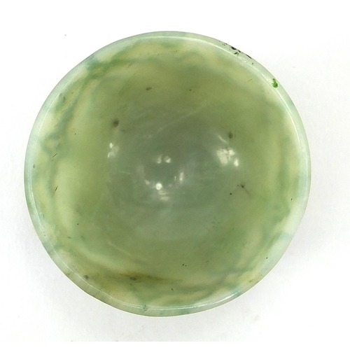 545 - Islamic green jade cup incised with stylised floral motifs, 6cm in diameter