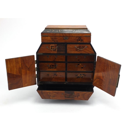 467 - Japanese lacquered table cabinet, having an inlaid geometric design, 36.5cm high