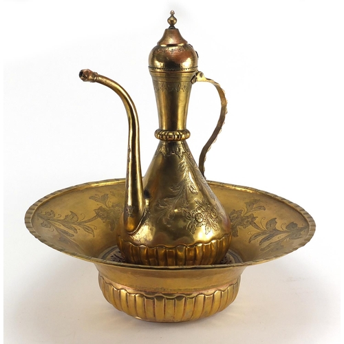 546 - Turkish gilt copper ewer and basin, all engraved with flowers, the ewer 40cm high