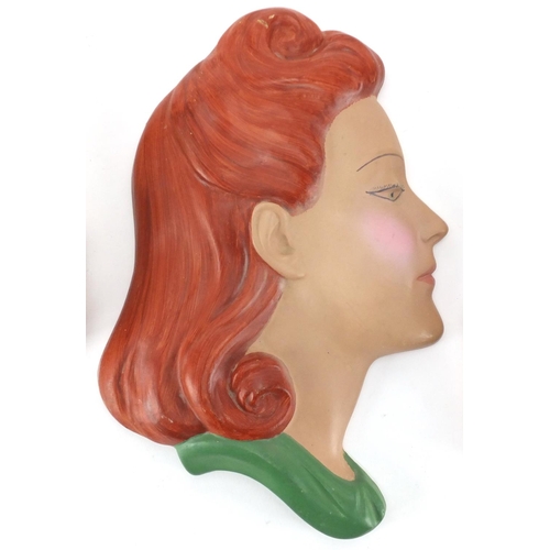 674 - Three hand painted Art Deco plaster wall masks, all of females, the largest 28cm high