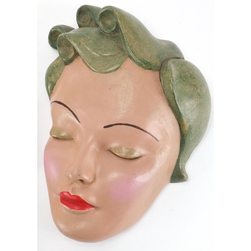 674 - Three hand painted Art Deco plaster wall masks, all of females, the largest 28cm high