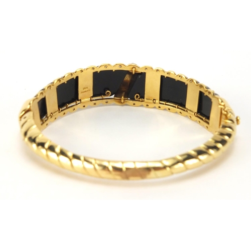 797 - Designer 18ct gold and black stone bangle set with diamonds, LWJ makers mark, 7cm in diameter, appro... 