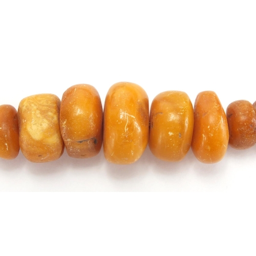 908 - Butterscotch coloured bead necklace and brooch, the necklace 32cm in length, approximate weight 66.0... 