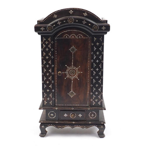 2028 - Indo Chinese table cabinet inlaid with Mother of Pearl and roundels of script, fitted with a cupboar... 