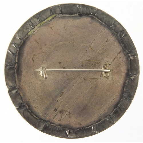 712 - Circular Ruskin high fired pottery brooch, 6.5cm in diameter