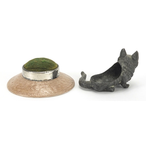 15 - Silver mounted bisque pin cushion, together with a lead cat pin cushion, the silver mounted example ... 