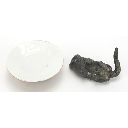15 - Silver mounted bisque pin cushion, together with a lead cat pin cushion, the silver mounted example ... 