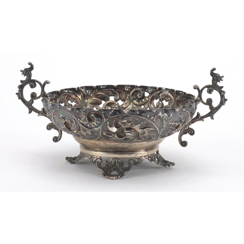 753 - Circular silver twin handle bon bon dish with embossed and pierced decoration, C. F London 1893, 11.... 