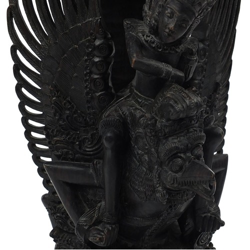 567 - Large well detailed Balinese hardwood figure group, carved with figures riding a turtle, 74cm high