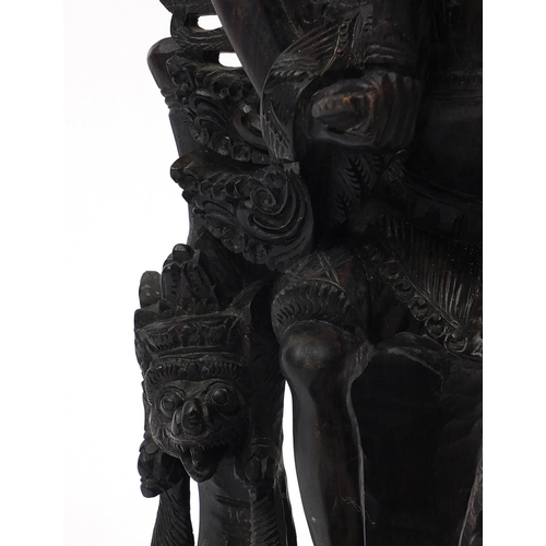 567 - Large well detailed Balinese hardwood figure group, carved with figures riding a turtle, 74cm high