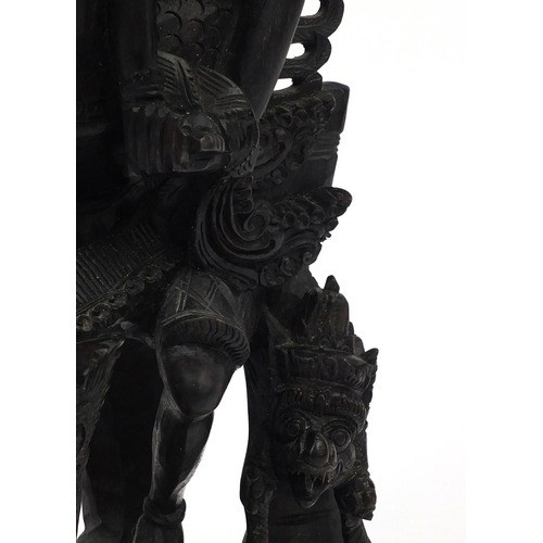 567 - Large well detailed Balinese hardwood figure group, carved with figures riding a turtle, 74cm high