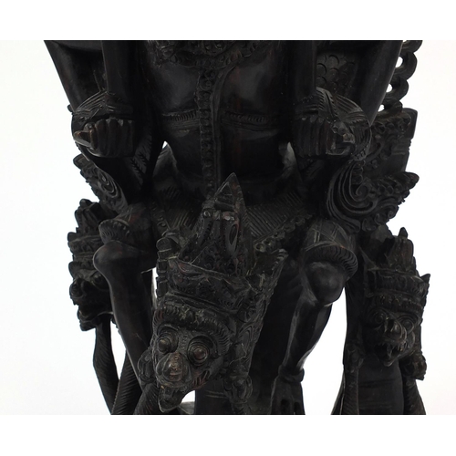 567 - Large well detailed Balinese hardwood figure group, carved with figures riding a turtle, 74cm high