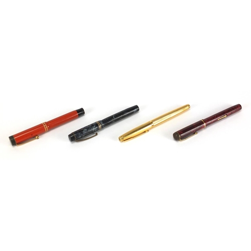 66 - Four fountain pens including an orange Parker Duofold lucky curve, red marbleised Conway Stewart No.... 