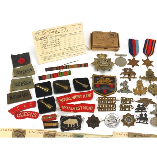 306 - British Militaria including World War II militaria including medal, cloth insignia, cap badges, silv... 