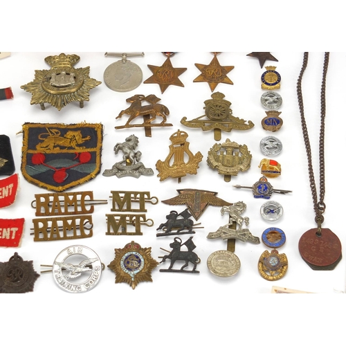 306 - British Militaria including World War II militaria including medal, cloth insignia, cap badges, silv... 