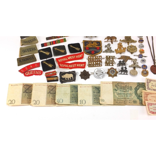 306 - British Militaria including World War II militaria including medal, cloth insignia, cap badges, silv... 