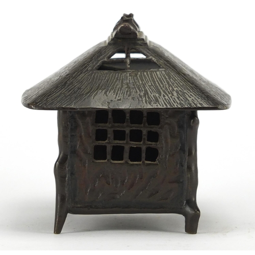 476 - Japanese bronze box and cover in the form of a hut, 9.5cm high