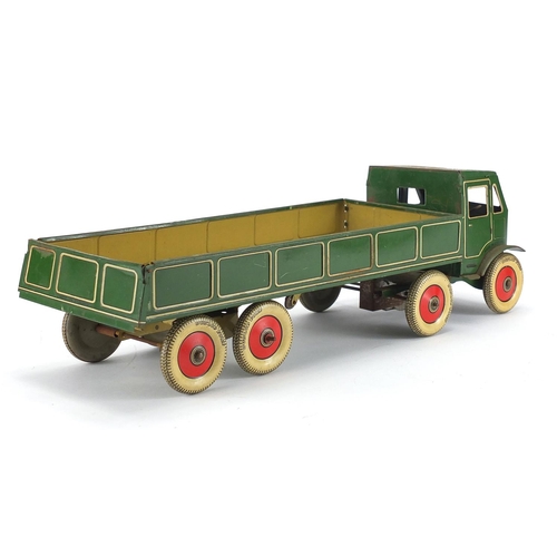 407 - Tin plate clockwork flatbed lorry with Dunlop Thorpe tyres, 42cm in length