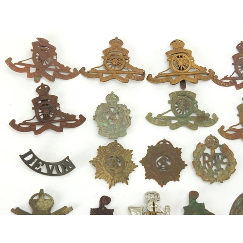 312 - Mostly British Military interest cap badges and buttons including Royal Sussex and Royal Engineers