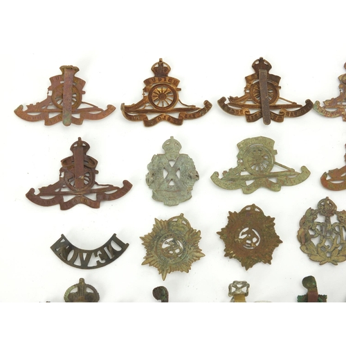 312 - Mostly British Military interest cap badges and buttons including Royal Sussex and Royal Engineers