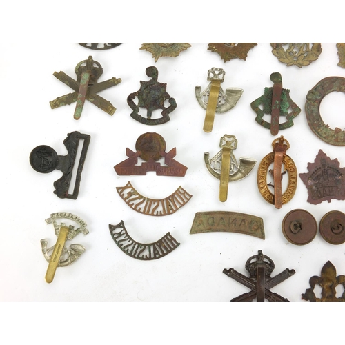 312 - Mostly British Military interest cap badges and buttons including Royal Sussex and Royal Engineers