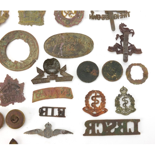 312 - Mostly British Military interest cap badges and buttons including Royal Sussex and Royal Engineers