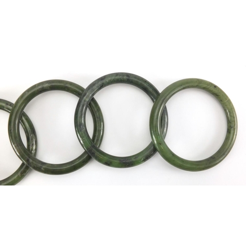 496 - Five Chinese spinach green jade bangles, each approximately 7.9cm in diameter, approximate weight 19... 