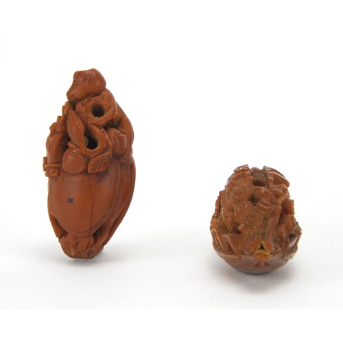 500 - Two Chinese coquilla nuts, one carved in the form of a junk the other of a monkey and horse, the lar... 