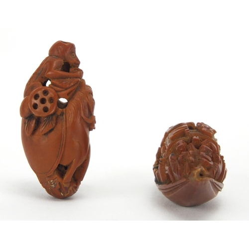 500 - Two Chinese coquilla nuts, one carved in the form of a junk the other of a monkey and horse, the lar... 