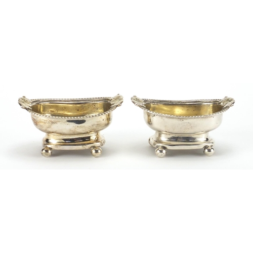 762 - Pair of Georgian silver open salts with shell shaped handles and ball feet, indistinct makers mark L... 