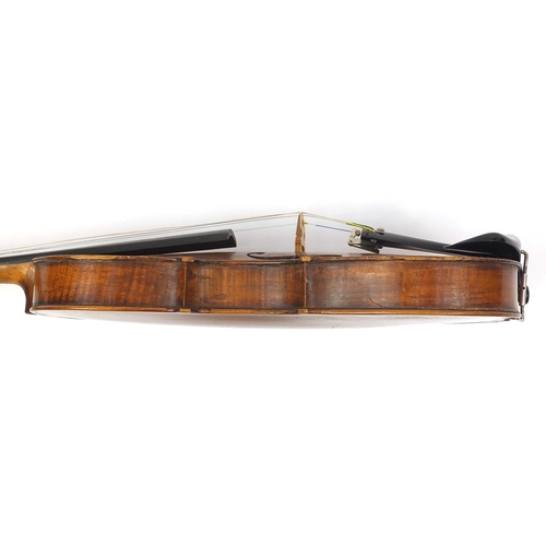 276 - Old wooden violin with one piece back and scrolled neck, together with two unnamed violin bows and f... 