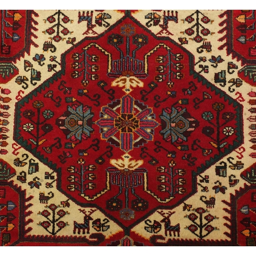 2025 - Rectangular Persian tribal rug, having an all over geometric desgin onto a red ground, 135cm x 135cm