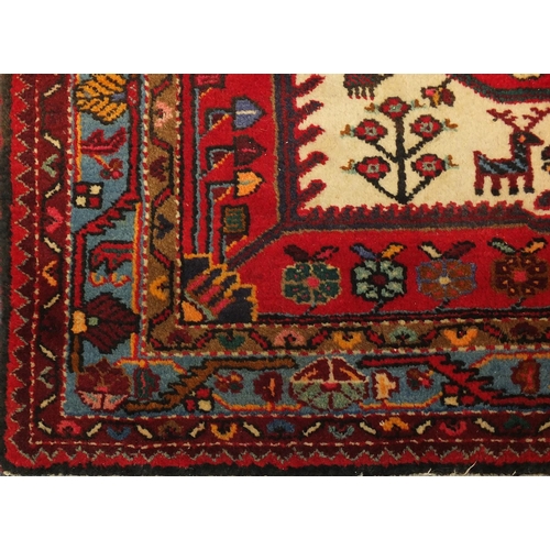 2025 - Rectangular Persian tribal rug, having an all over geometric desgin onto a red ground, 135cm x 135cm