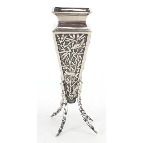 524 - Chinese silver vase of square tapering form with simulated bamboo legs, embossed with birds of parad... 