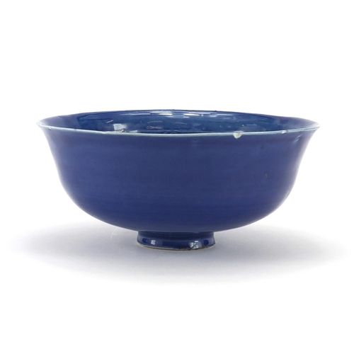 457 - Chinese blue glazed footed bowl decorated in low relief with two dragons, 19.5cm in diameter